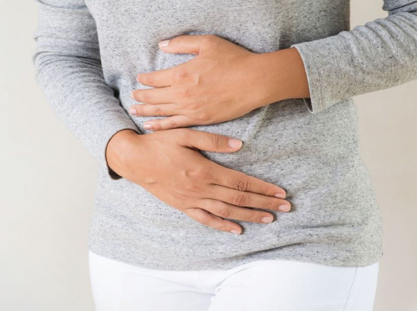 Female Hands around stomach for gut health
